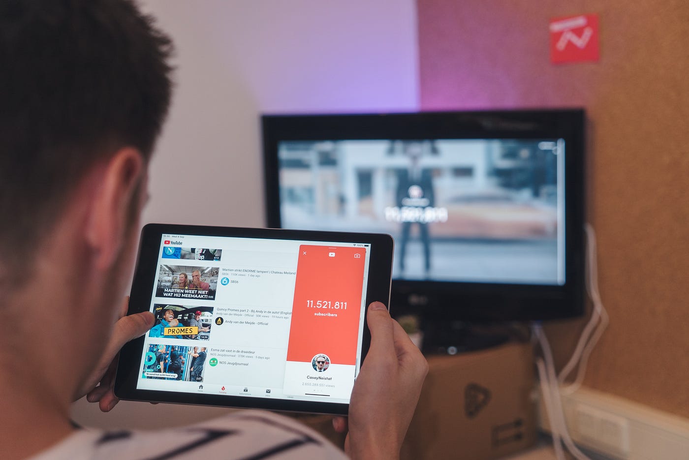 A guy watching youtube videos on his tablet